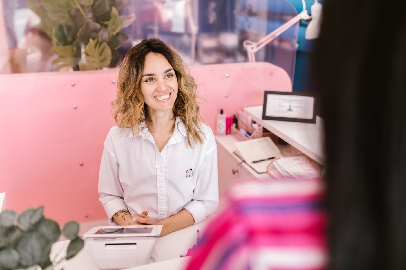 A front-desk professional welcoming a visitor