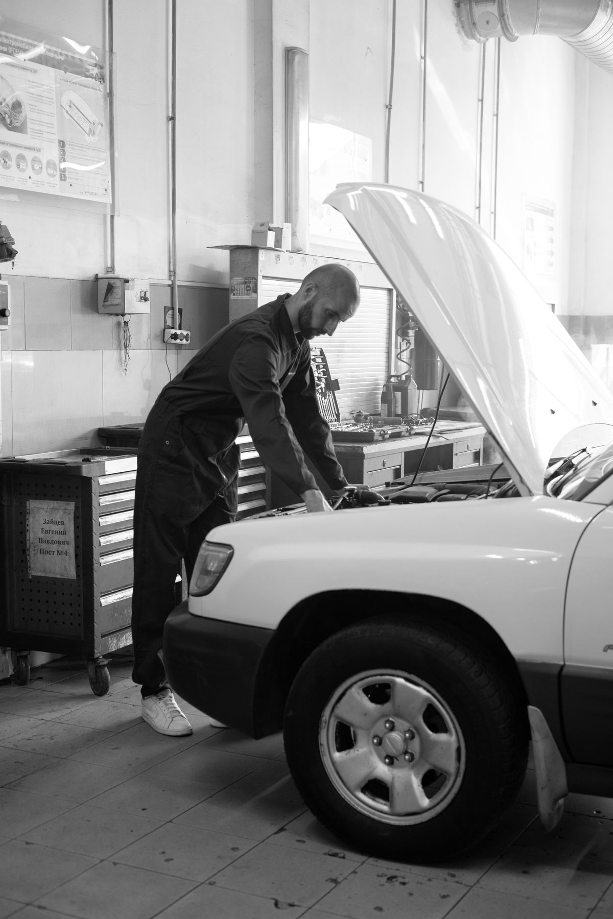 A mechanic working on a car in a service workshop